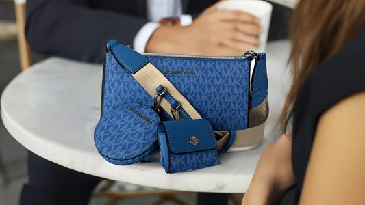 Michael Kors bags for women Jet Set Signature Crossbody Bag. Man and women sitting at a park table.
